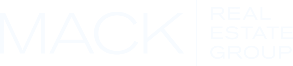White logo displaying the words "MACK REAL ESTATE GROUP" in large, thin, capital letters on a light gray background.